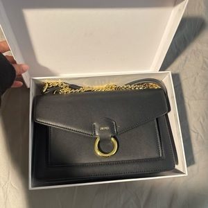 JW PEI Black purse with gold accents and chain